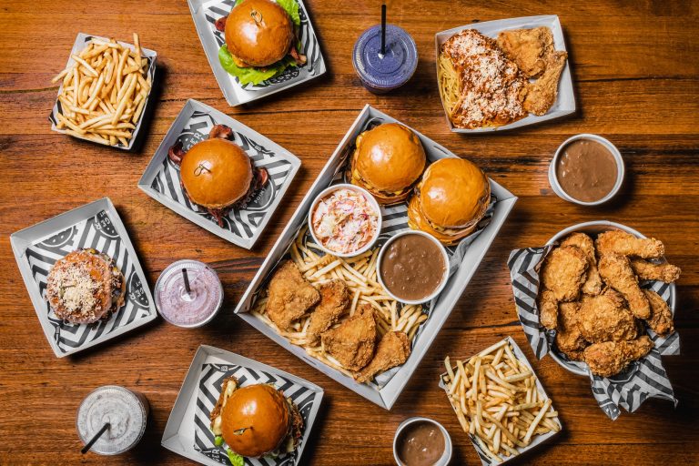 Overlay of Food items spread over a wooden table from Burger Point